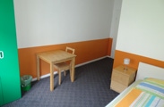 This room has a small seating area, a desk, TV with local channels and a private bathroom. 