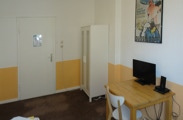 This room has a small seating area, a desk, TV with local channels and a private bathroom. 