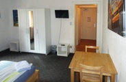 The room up to 5 persons consists of two rooms with connecting door and private bathroom. One room is equipped with 3 single beds, the other has a large double bed and TV with international channels. 